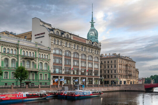 St. Petersburg, Russia, April 30, 2023: View of the historical building of the store "At the Red Bridge" of the Belgian-Dutch trading company "S.Esders and K.Scheifals" on the Moika River embankment