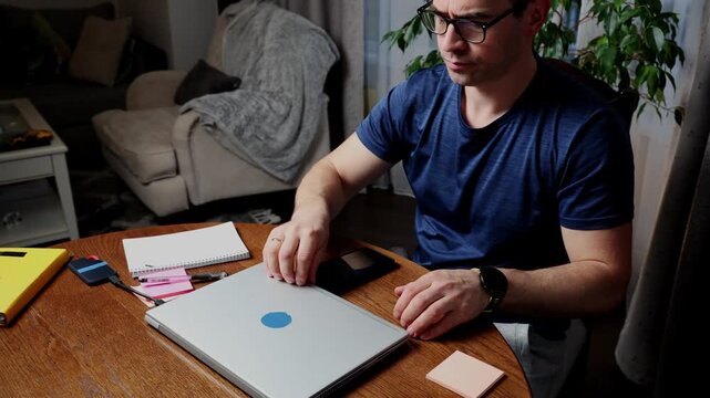 Freelancer working from home at a desk with a laptop and smartphone while staying productive