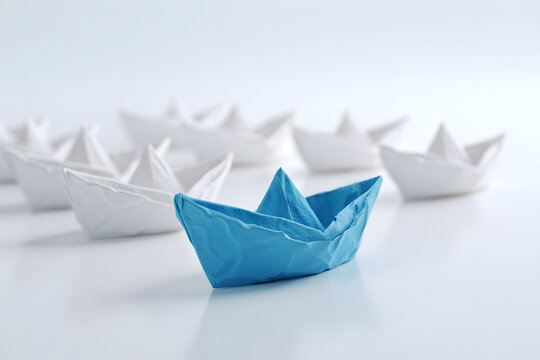 Leadership concept, blue leader boat leading white boats, on white background