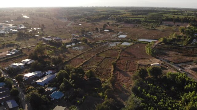 Drone shot is showing rice paddy areas in preparation for the next planting cycle in northeastern Thailand.