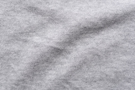 Close-up texture of grey cotton-modal blend fabric. Smooth, soft, and high-quality textile material with a fine weave. Ideal for fashion, apparel background, or garment industry concepts.