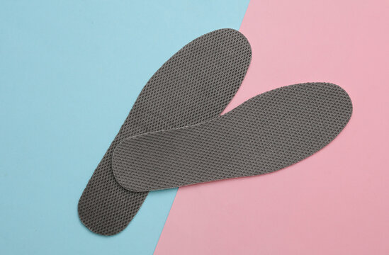 Insoles on pink blue background. Top view