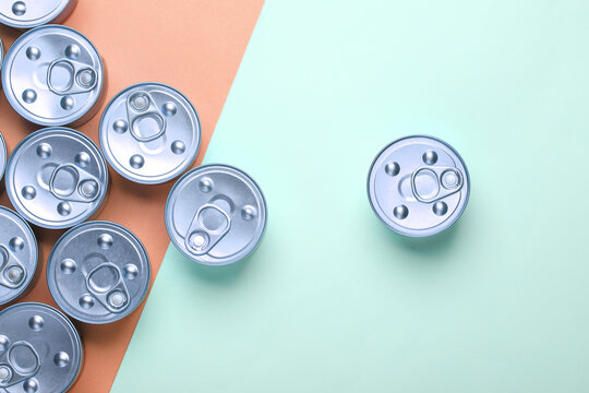 Cans with canned food on pink blue pastel background. Top view. Flat lay