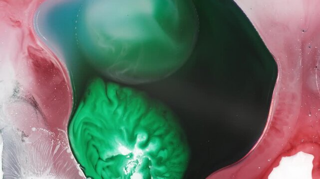 vibrant green pigment spreading through a pink and purple liquid landscape, mimicking a microscopic galaxy in a studio packshot.