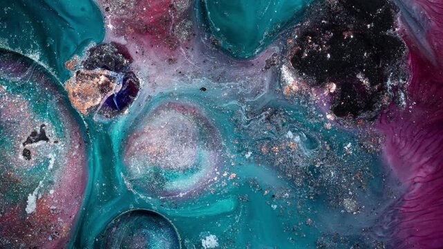 Top-down macro perspective of turquoise and rose-colored alcohol ink forming organic circular patterns and shimmering gold textures in a high-contrast cinematic style.
