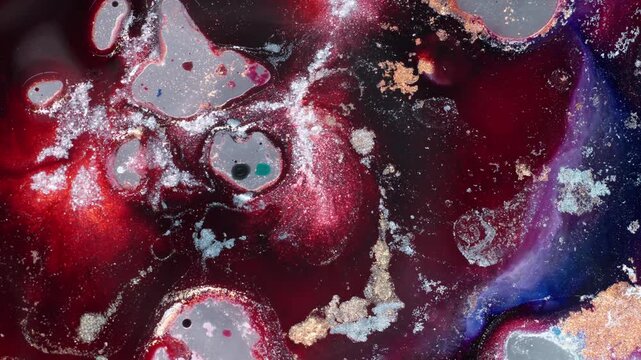 Macro top-down view of pink alcohol ink merging with metallic silver pigments. An evocative abstract sequence exploring color evolution and fluid emotions in high contrast.