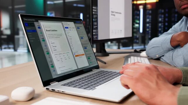 Two Managers Review Document System On Laptop