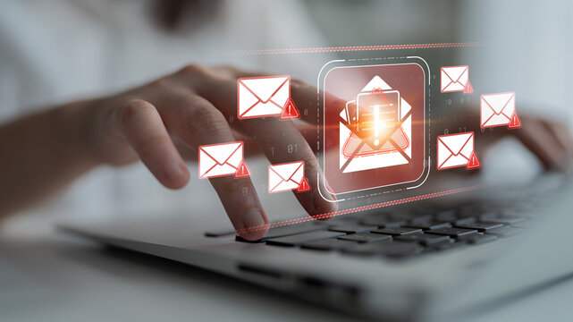 Hand Using Laptop Keyboard with Email Alerts and Notifications Displayed on Screen, Concept of Digital Communication and Cybersecurity Risks Sigmoid