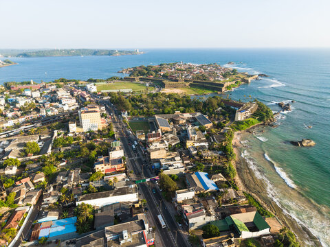 Aerial view of the historic Galle Fort on the peninsula overlooking the Indian Ocean with the cricket stadium and urban buildings Galle, Southern Province, Sri Lanka.