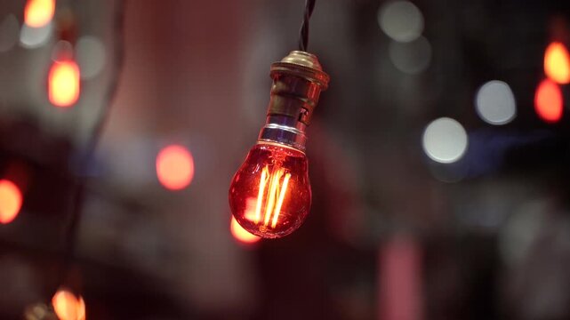 Decorative light bulbs with warm glow in evening atmosphere with bokeh background.