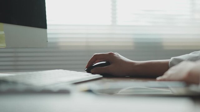 Close up of a hand using a computer mouse