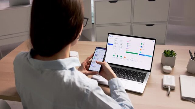 Human Resource Manager Reviewing Employee Data On Smartphone