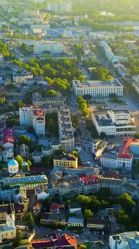 Vertical video. Simferopol, Crimea. Council of Ministers building, neoclassical government complex at the heart of Lenin Square, aerial panoramic view at sunset. Drone footage. Rich colors