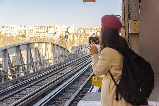 Woman traveling solo exploring paris bir hakeim metro station