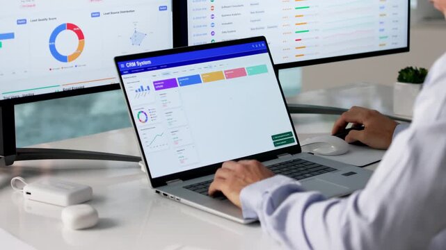 Sales Manager Reviewing Customer Data On Computer