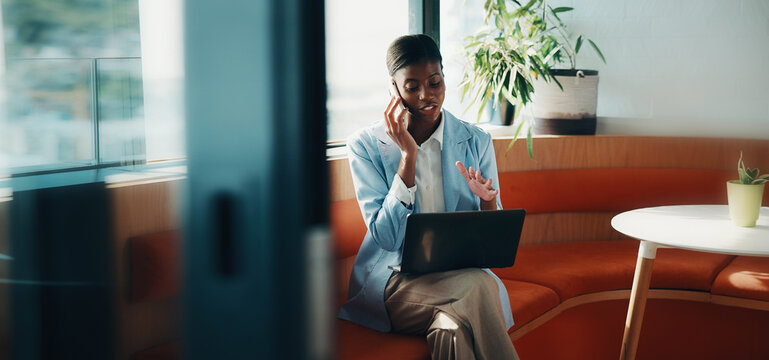 Laptop, office and black woman with phone call for communication, copywriting or opportunity. Discussion, advice and editor talking on mobile, contact or support for online editing in startup agency