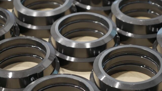 Metal circular flanges. Pipeline industrial equipment maintenance at manufacturing plant factory. Industry. Round metal flange with eight bolt holes, machined grooves, and a polished surface