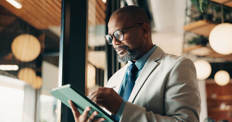 Businessman, glasses and research with tablet in cafe, private wealth attorney and will draft on web. Black person, estate planning and mature lawyer with tech for project or remote work in office © peopleimages.com