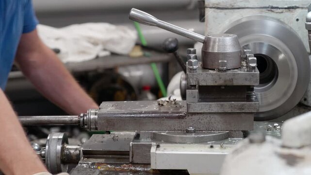 Lathe industrial turning machine operation. Cnc milling machine in operation with metal gear. Worker manual setup in machine shop, Precision alignment ensures secure clamping .