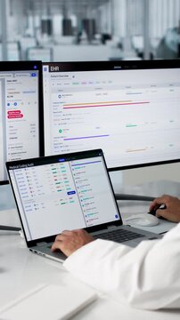 Medical Coder Carefully Reviewing Patient Data On Laptop