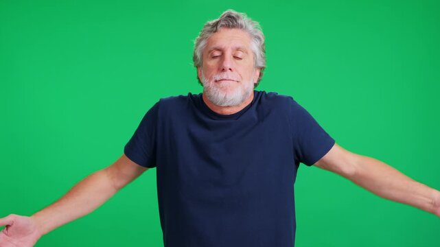 Mature man making resigned faces on green screen background