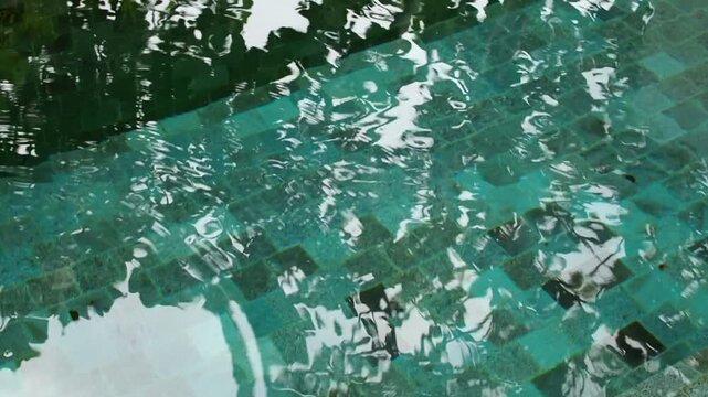 Waving water in the pool, rest and relax background. 