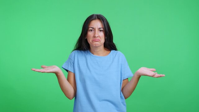 Confused woman shrugging shoulders with doubtful expression