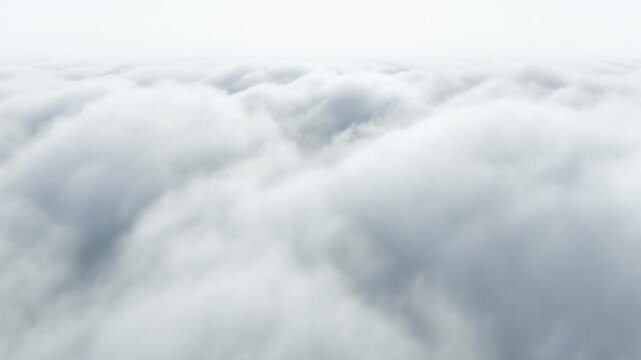 White fluffy clouds from aerial perspective. Thick cumulus cloud layer covering sky. Bright daylight atmosphere. Static camera shot. Soft textures. Cinematic stock footage for weather.