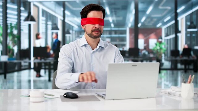 Blindfolded Businessman Works Focused On Laptop