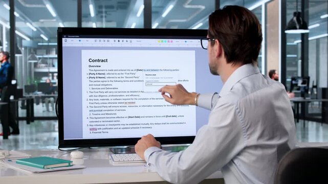 Man Editing Handwritten Document On Computer