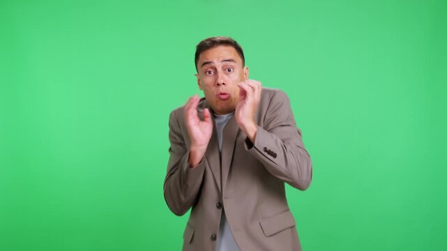 Scared businessman feeling terror and fear against a green screen