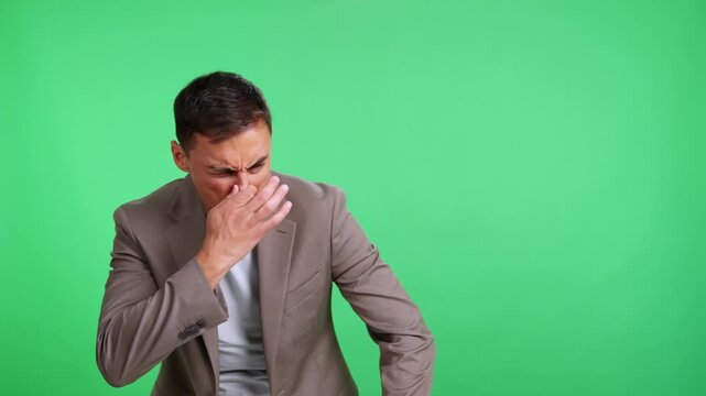 Caucasian man grimacing at a bad smell