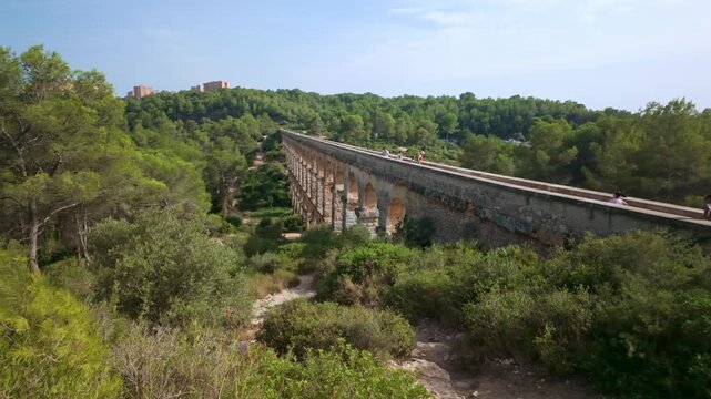 People walking on the old roman aqueduct of Tarragona