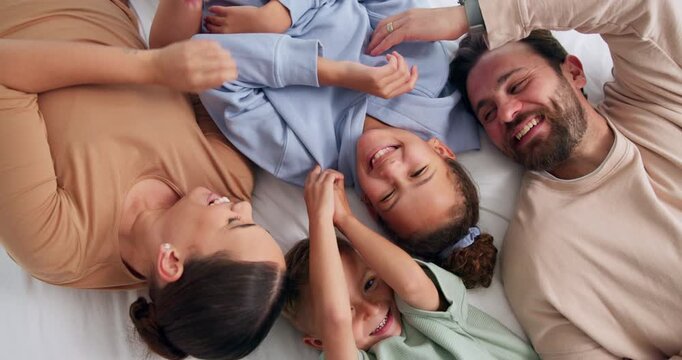 Parents, children and laugh with tickle on bed, above and bonding with funny game at family house. People, kids and happy with fun, playful and connection with love, care or laying at apartment