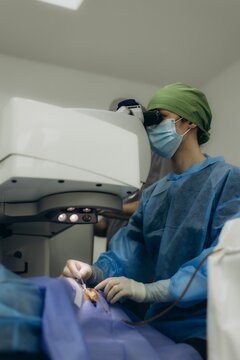 Ophthalmologist performing laser vision correction surgery on patient