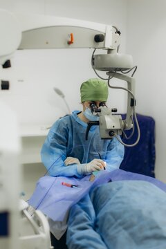 Ophthalmologist surgeon performing eye operation with microscope
