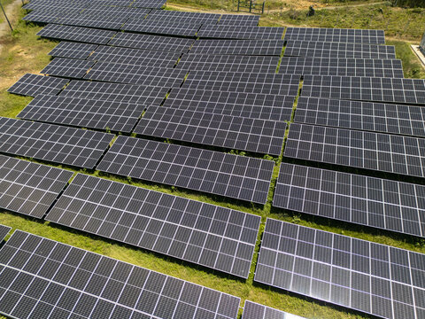 Aerial view of the Guanaja solar farm with rows of photovoltaic panels on a grassy field Guanaja, Bay Islands Department, Honduras.