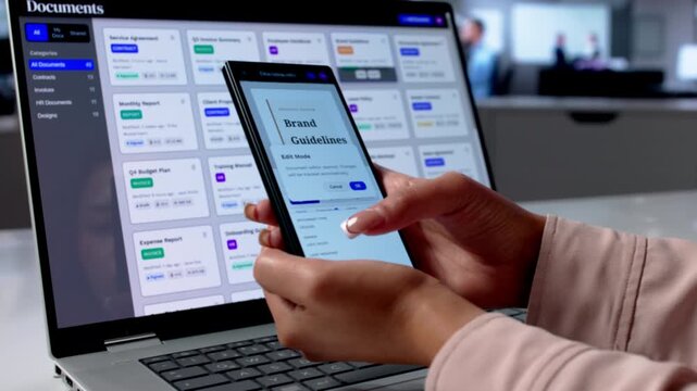 Business Analyst Reviews Document Workflow Using Smartphone
