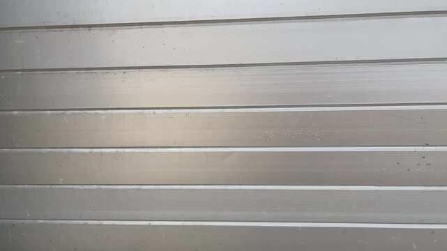 Silver metallic rolling door texture background loop