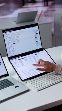Quality Manager Reviews Corrective Action Reports On Laptop