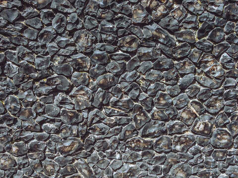 An example of a traditional flint wall, durable masonry construction made using flint nodules