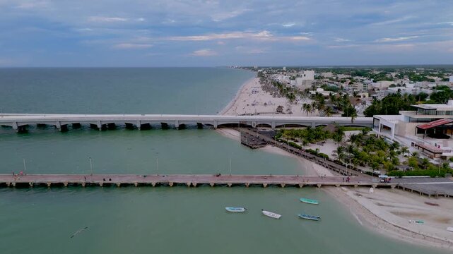 High Aerial View of Long Viaduct Pier and Beachfront Coastline in Progreso Yucatan, Mexico. Aerial landscape shot captures the unique intersection of infrastructure and coastal scenery.