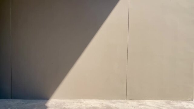 Concrete wall background with diagonal shadow and sunlight