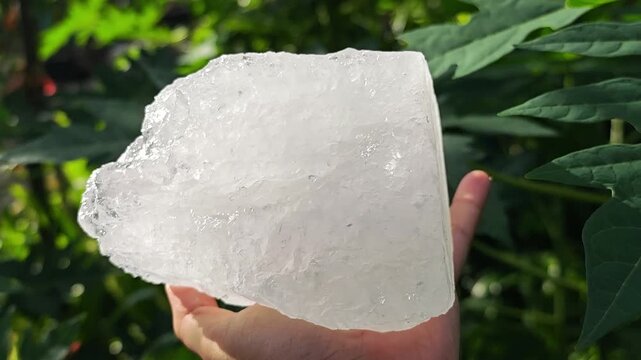 Crystal clear alum in hand.