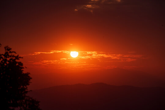 Beautiful landscape foggy hills twilight time. Blue golden sky sunrise dramatic beautiful landscape mountain. Dawn sky gold dusk time cloudscape with sunlight. Dramatic sunset over mountain landscape