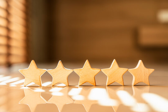 Five stars rating icon on table in sunlight, business credit score credibility and customer review feedback concept.