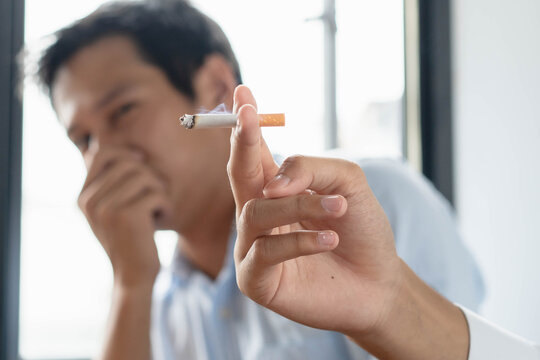 passive smoking effect, person cover his nose and avoid smoker near him