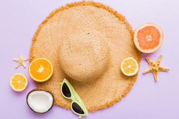 Top view of various seashells placed near colorful fruit and stylish summer accessories on table background. Summer concept. Flat lay. Top view with copy space for text © sosiukin