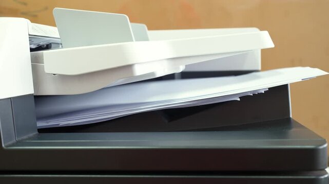 Pile of A4 paperwork documents are print out from photocopy machine in fast motion. 4K footage.