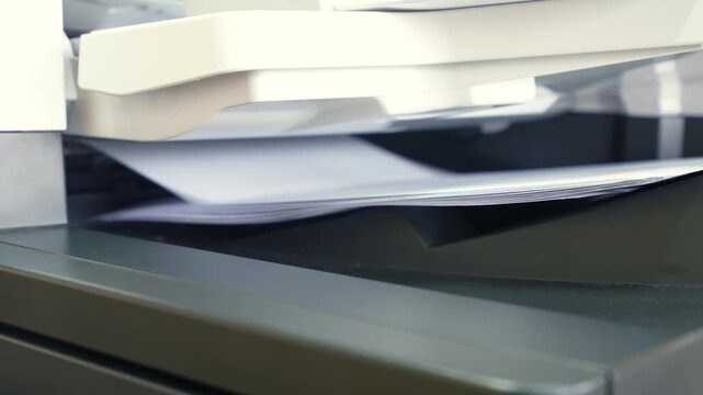Pile of A4 paperwork documents are print out from photocopy machine in fast motion. 4K footage.